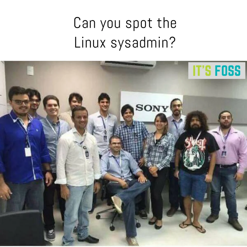 enterprise team with formal people and a guy with beard and black shirt: &ldquo;spot the linux sysadmin&rdquo;